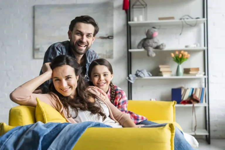 Happy family sitting on the living room couch