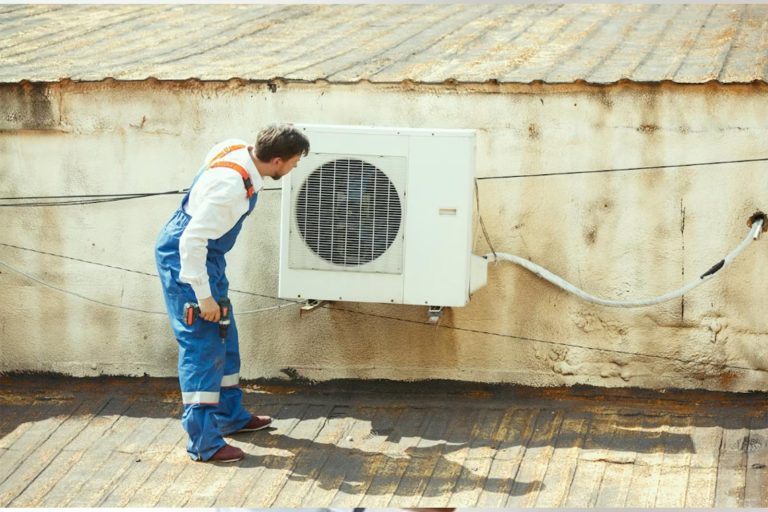 AC Repair New Lenox - Worker reparing ac unit - Happy Hippo Heating and Cooling